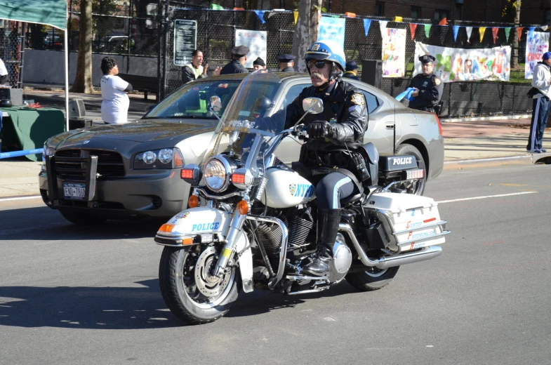 there is a man riding on a police motorcycle