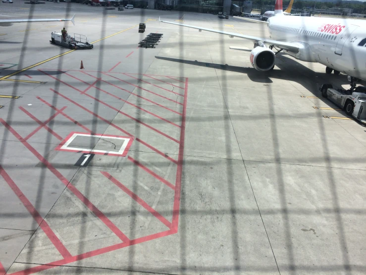 a airplane that is on a runway next to a gate