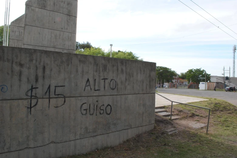 graffiti written on a wall outside the gates