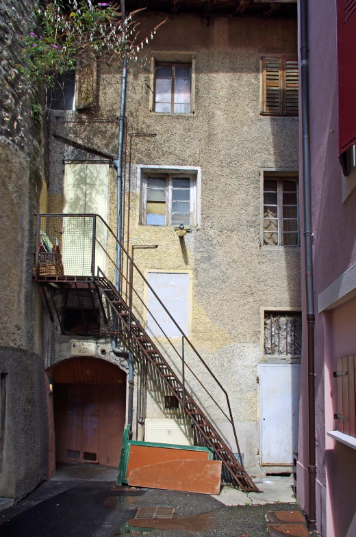 the stairs lead to the second story of this rundown building