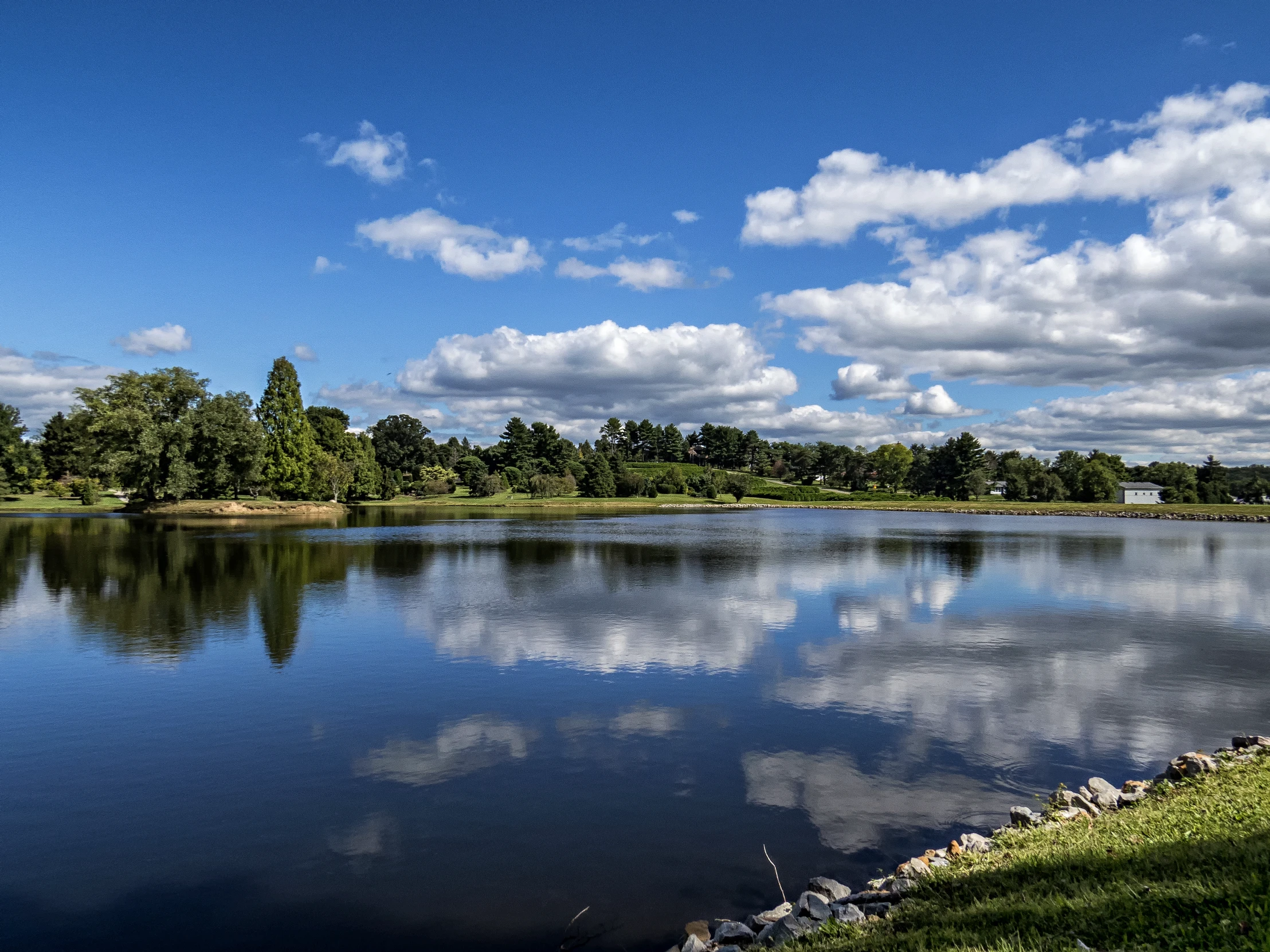 the sky reflecting in the water in a park