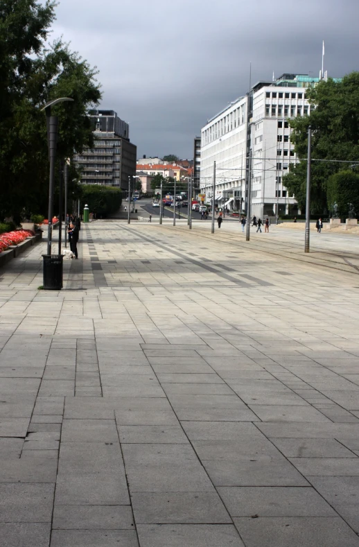 an empty concrete walkway in a large city