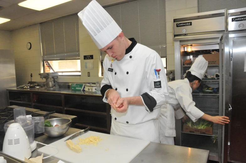 two chefs in a kitchen preparing food