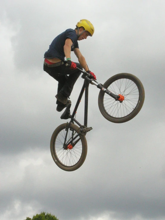 a man doing a trick on a bicycle upside down