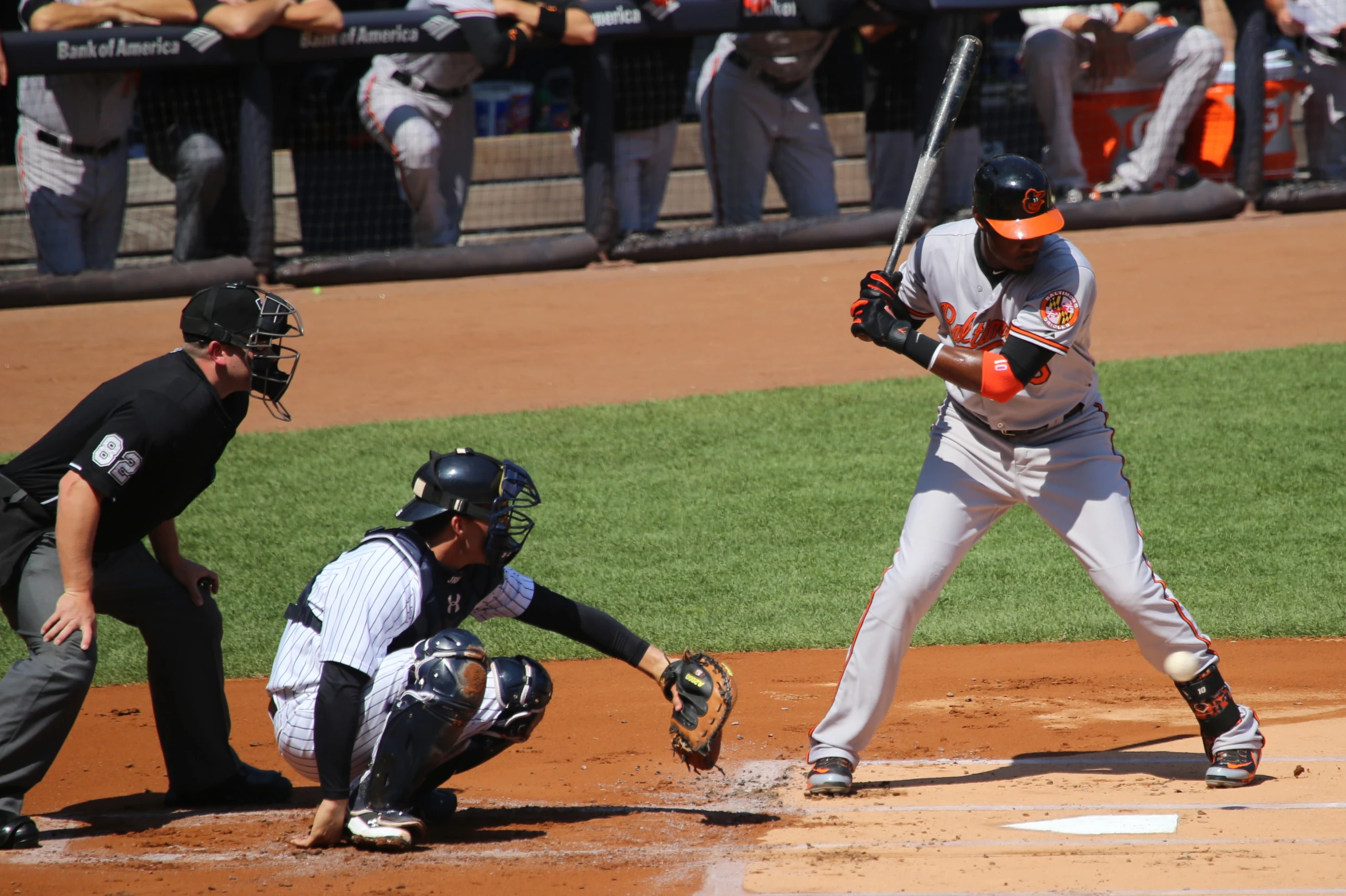 baseball player in white uniform holding a bat on a field