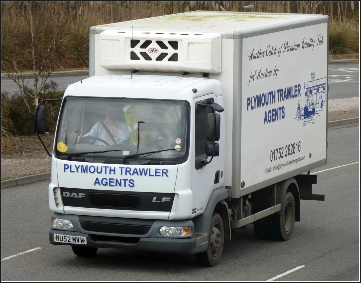 a truck driving down the street on a highway