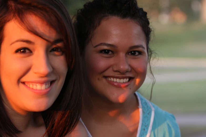 two women smile and pose for the camera