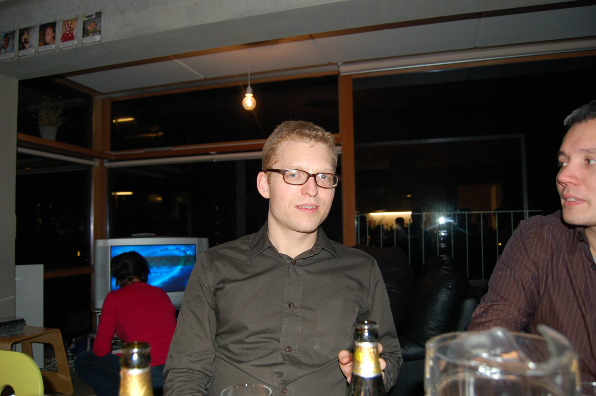 two men sitting and drinking beer in a bar