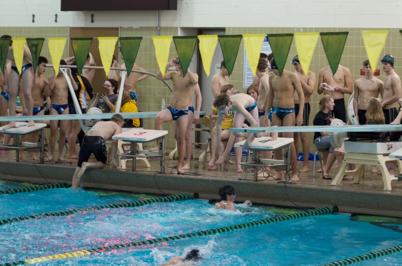 swimmers take a turn in an indoor swimming pool