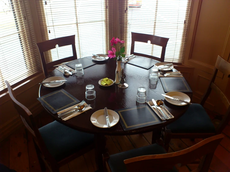 a dinning room table and place settings
