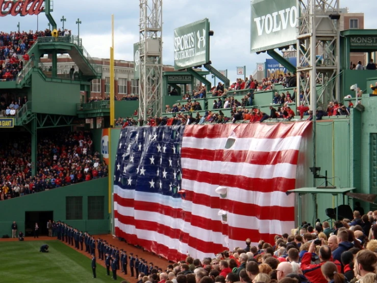 some fans and a giant flag in a crowd