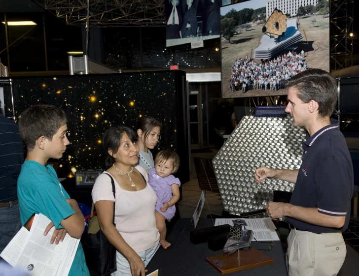 people at a convention looking at images on the wall