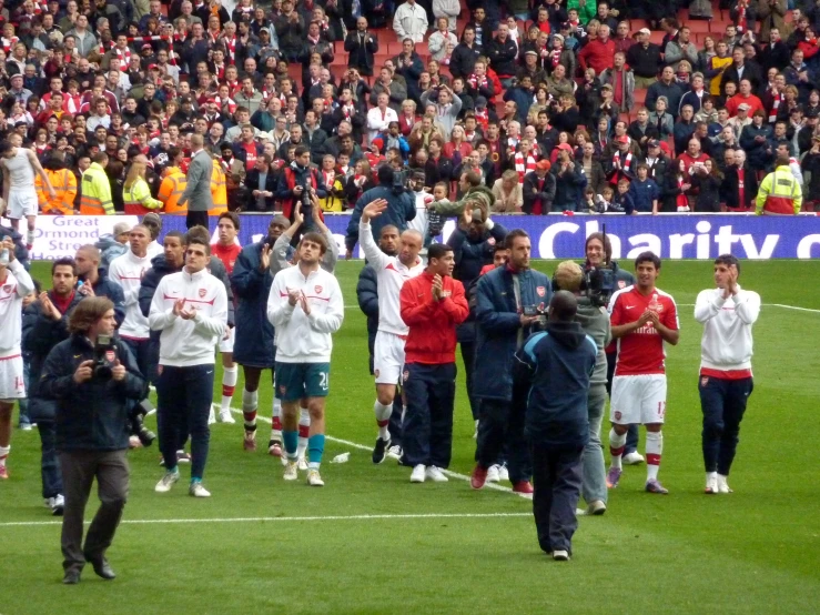 several soccer players are on the field with others