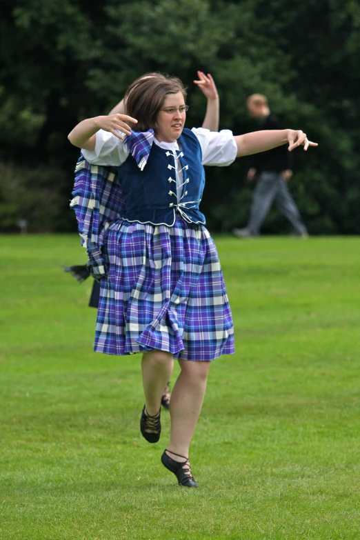 a person in a kilt is flying through the air