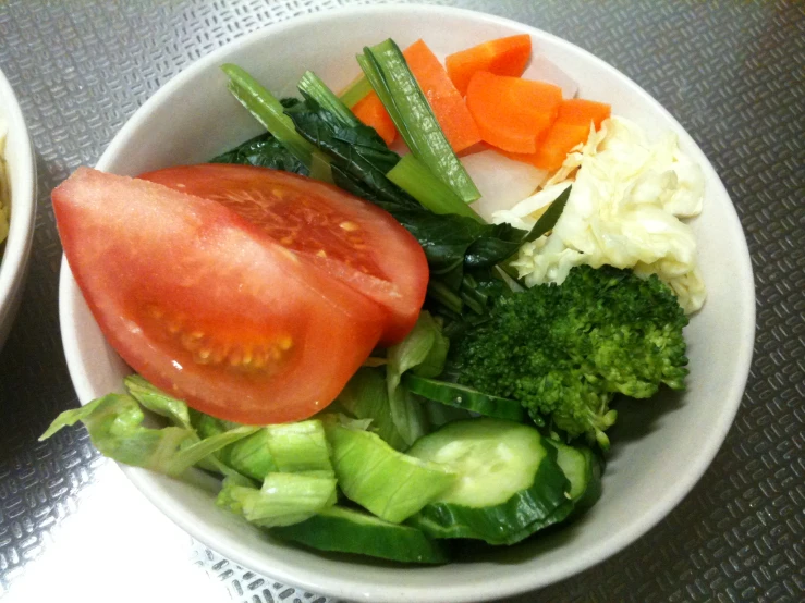 a bowl of vegetables is on a table