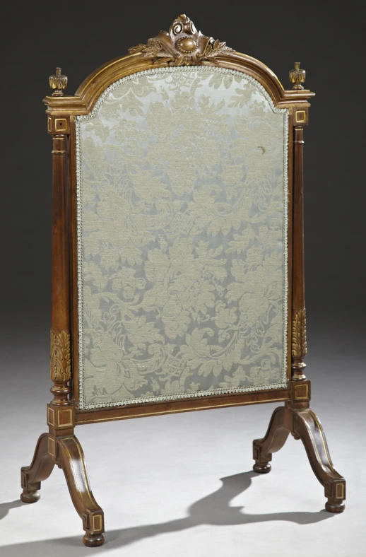 an ornately framed wooden mirror sitting on top of a table