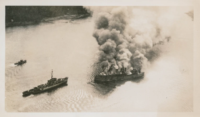 two large boats are near a large tanker