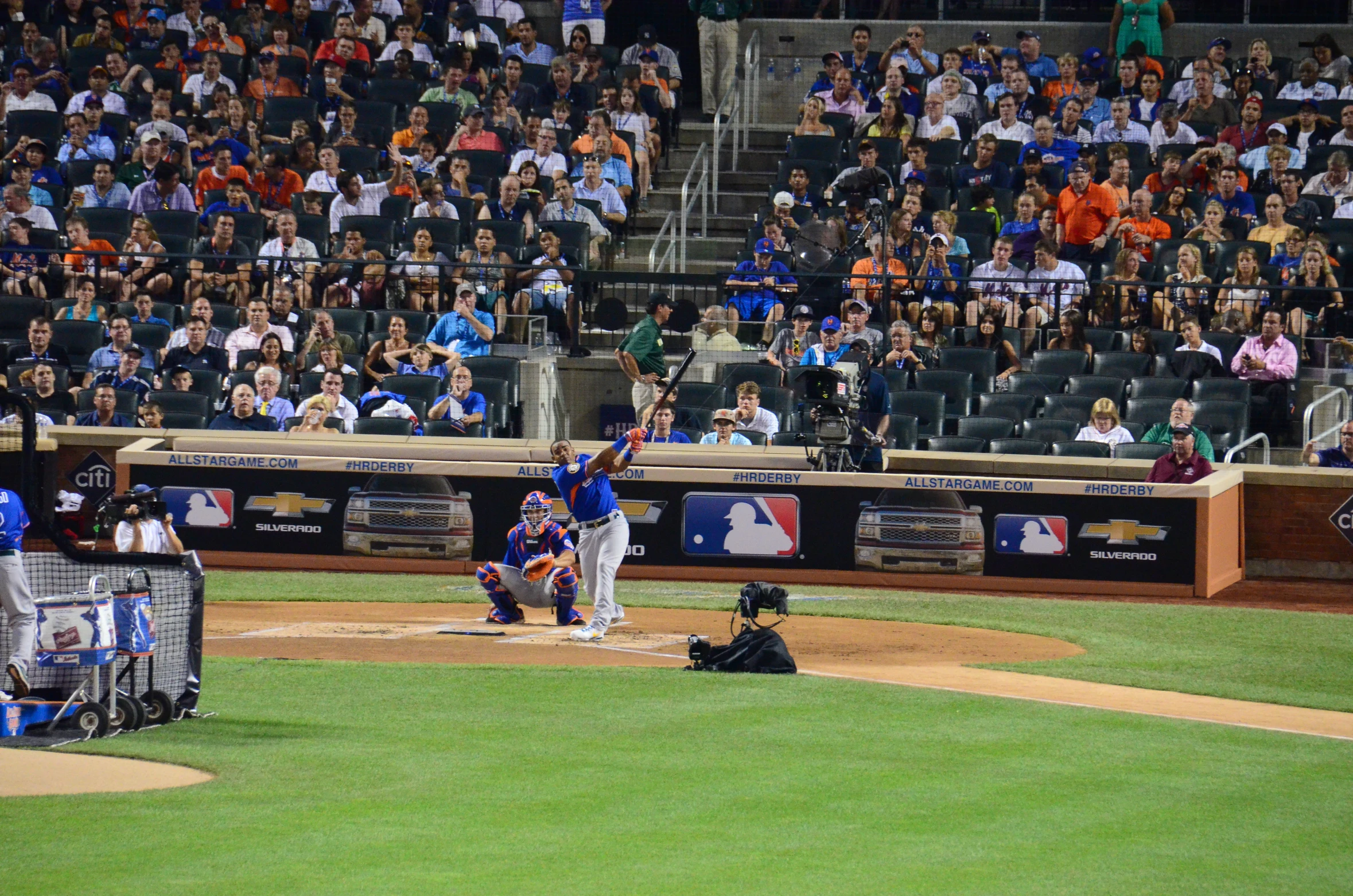 baseball players playing a game with many fans watching