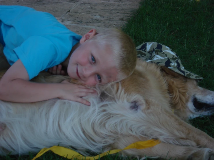 a child cuddles his dog for the camera