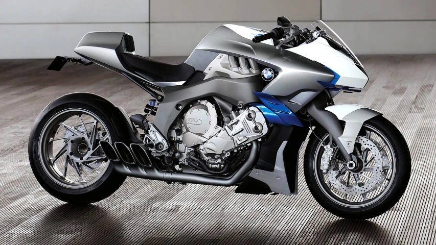 a metallic and blue motorcycle parked on a hard wood floor