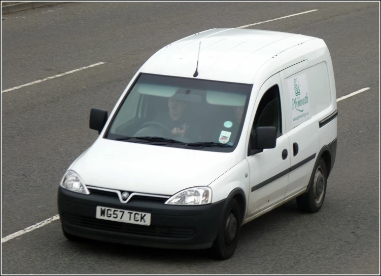 an older woman is driving in a small van