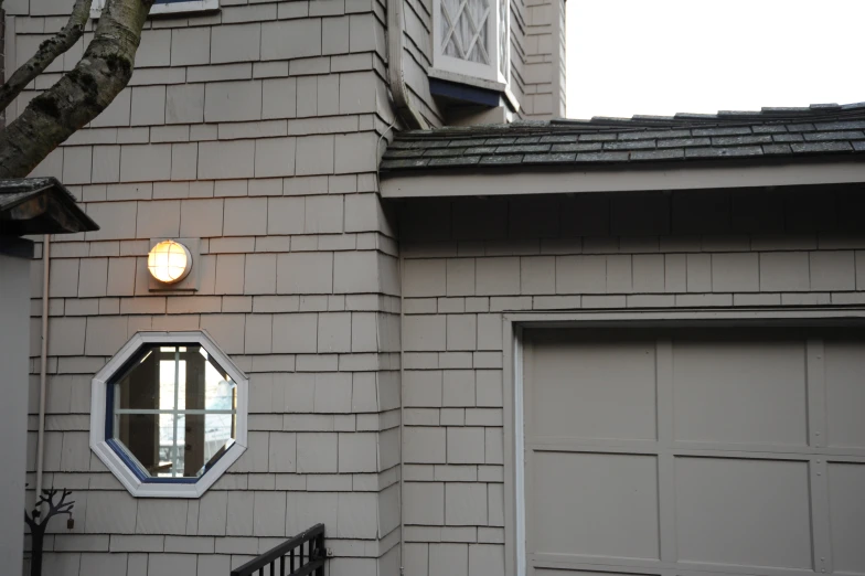 an empty door on a brick building with round windows