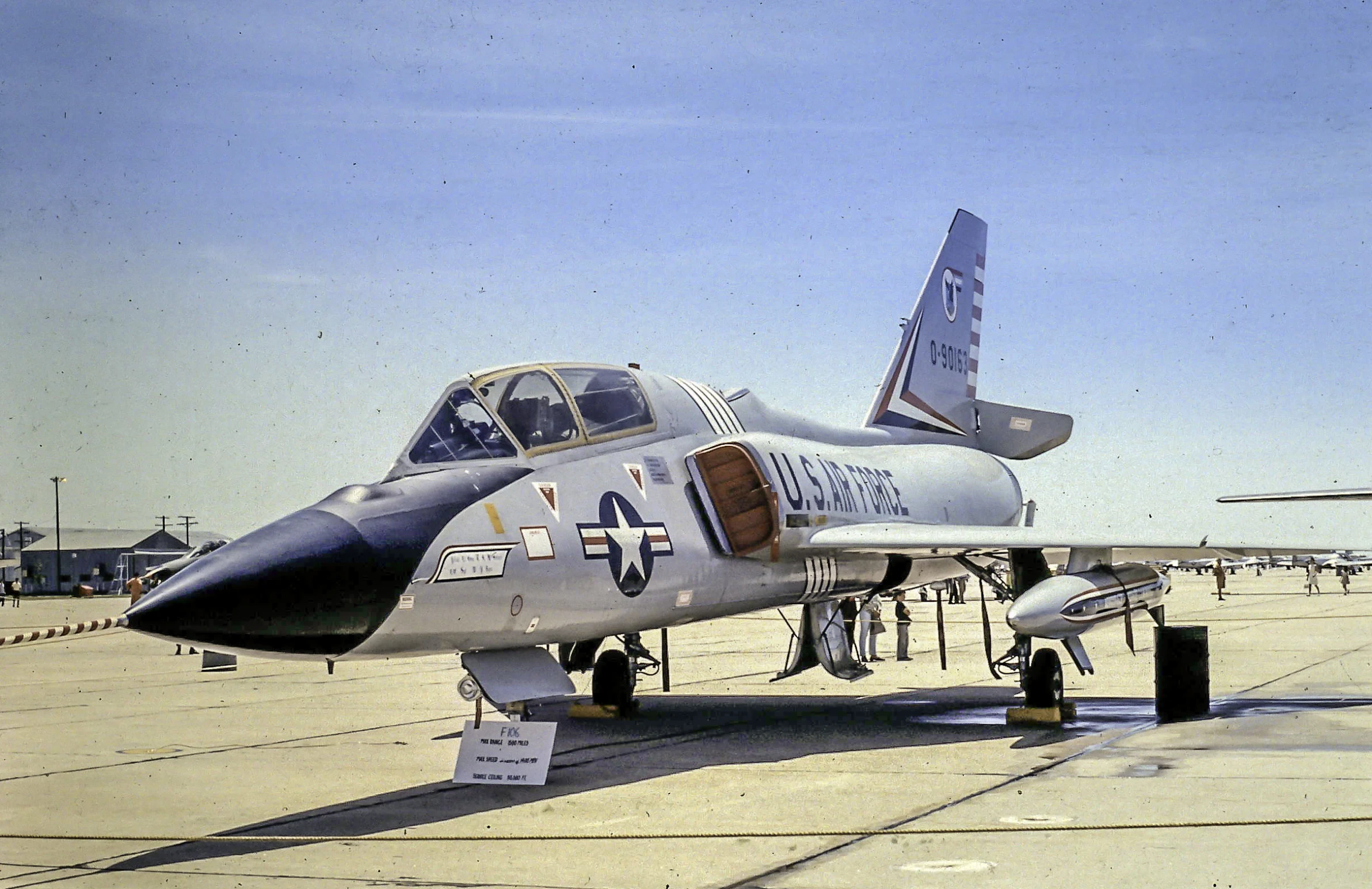 a jet fighter parked on a tarmac with other planes