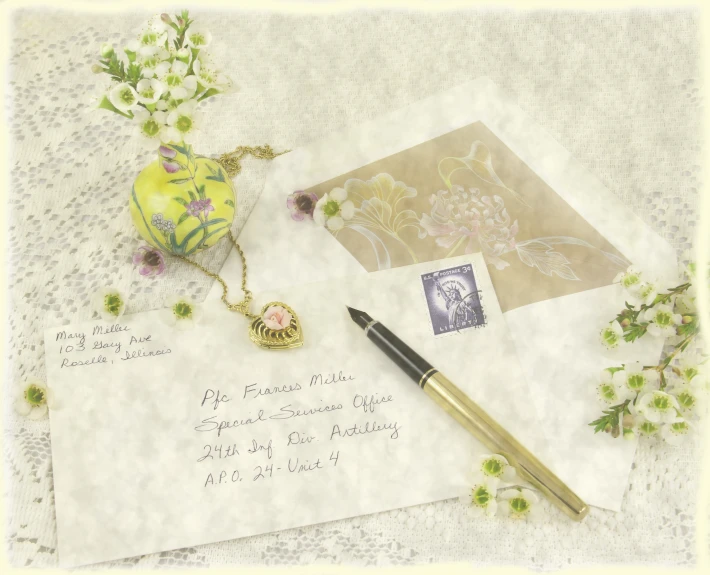 an old fashioned fountain pen and a letter on a lace covered table