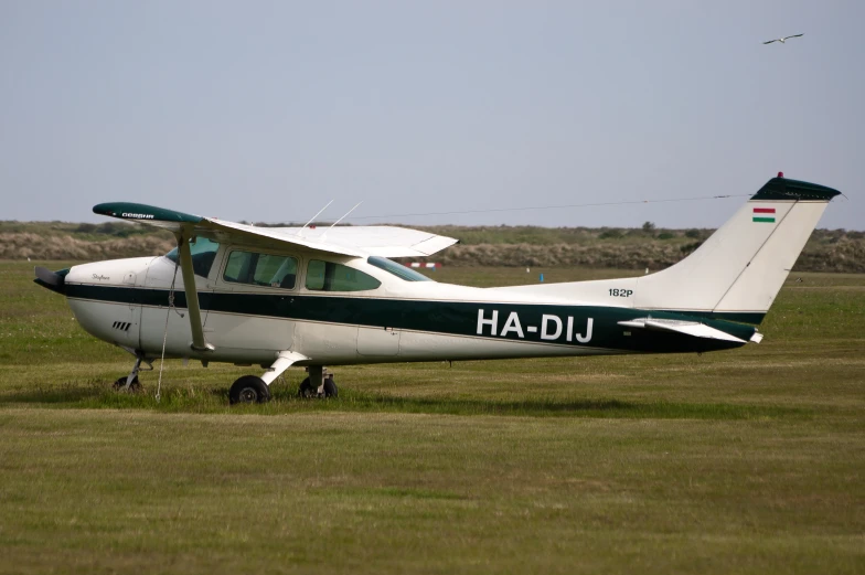 the small airplane has landed on the grassy field