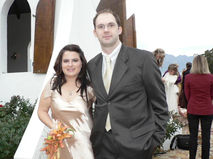 a couple standing in front of the chapel