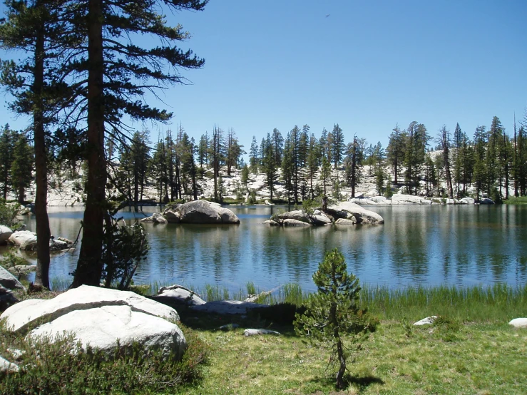 the water is calm and it has rocks in it