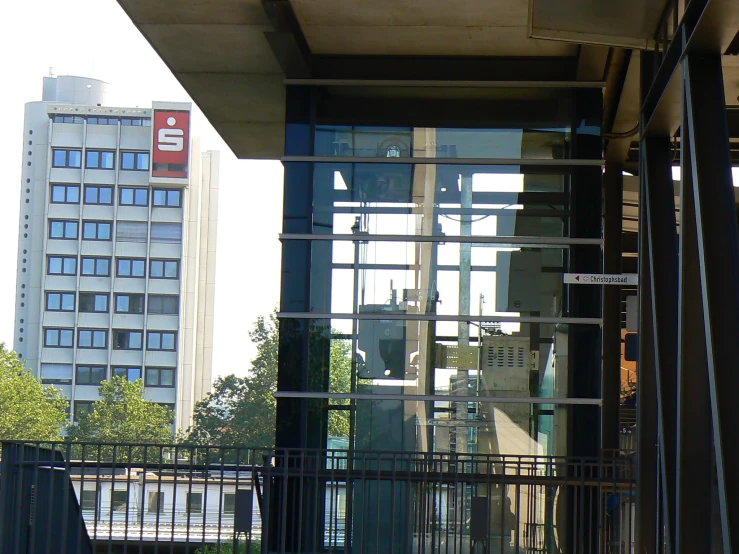 a large open building with a clock tower and window reflection