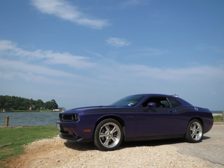 a purple car parked on the side of a road