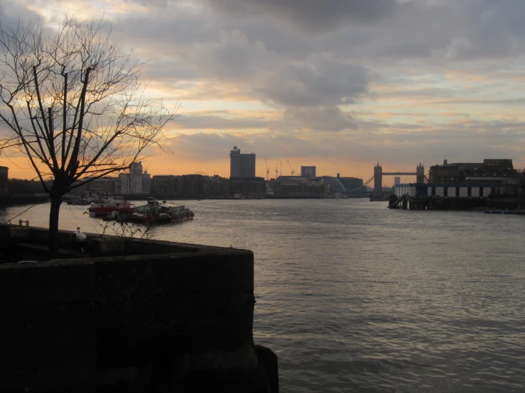 the view of a harbor and boats at dusk