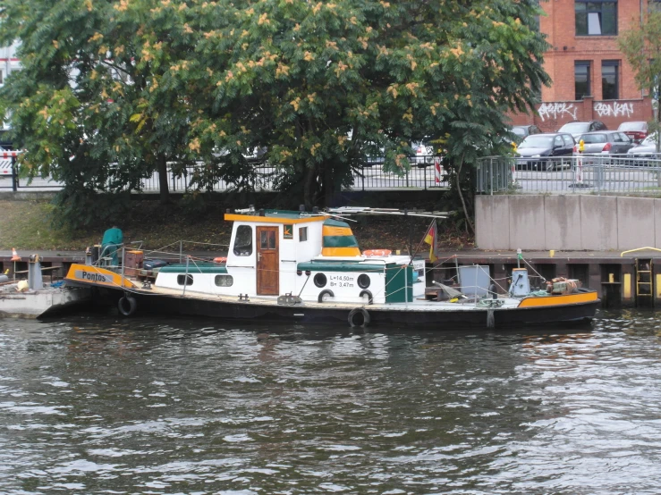 a white tug boat on the side of the water