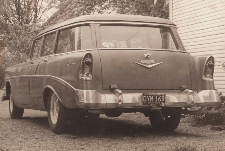 a older car that is parked in the driveway