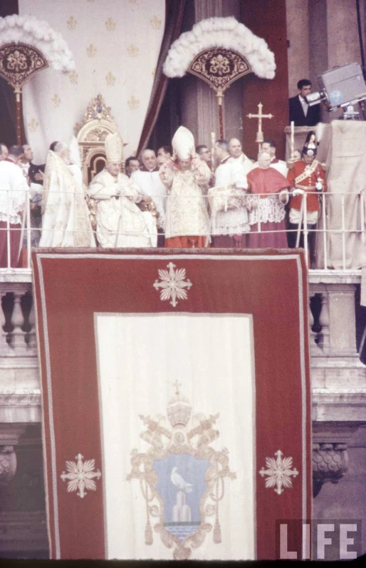 there are two men standing on a podium and other people