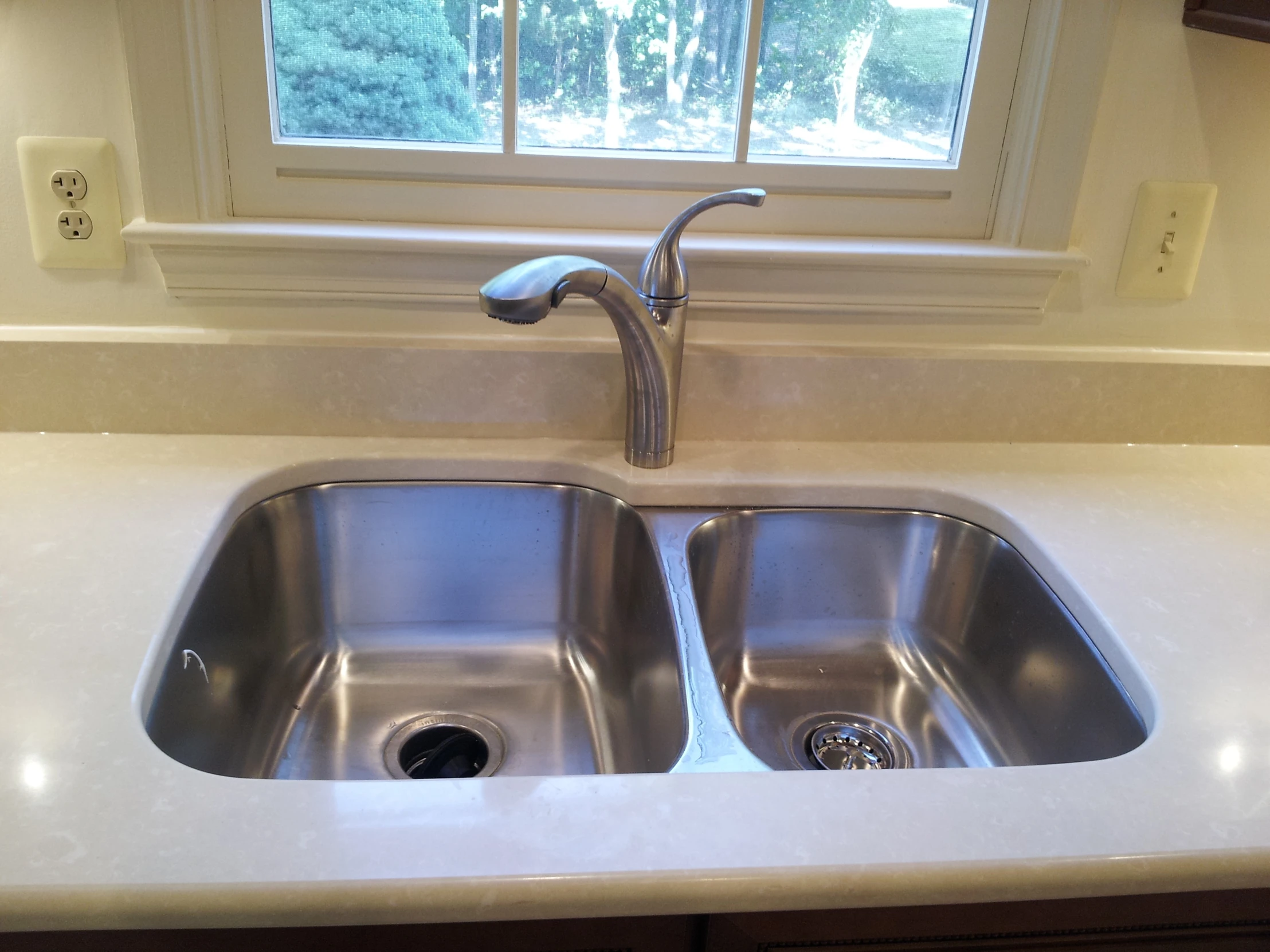 double stainless steel sink in kitchen next to window