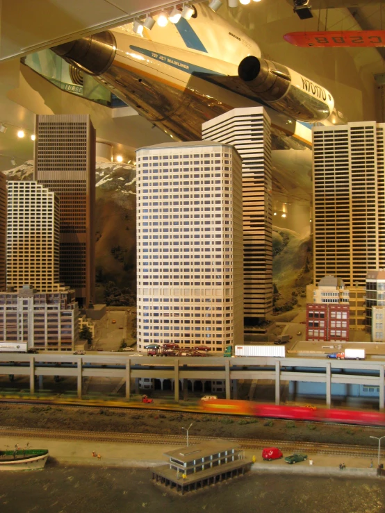 a model airplane is in front of the cityscape