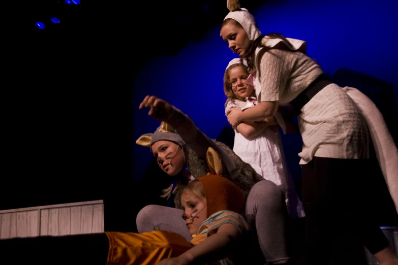 three young children are posing while they are on stage