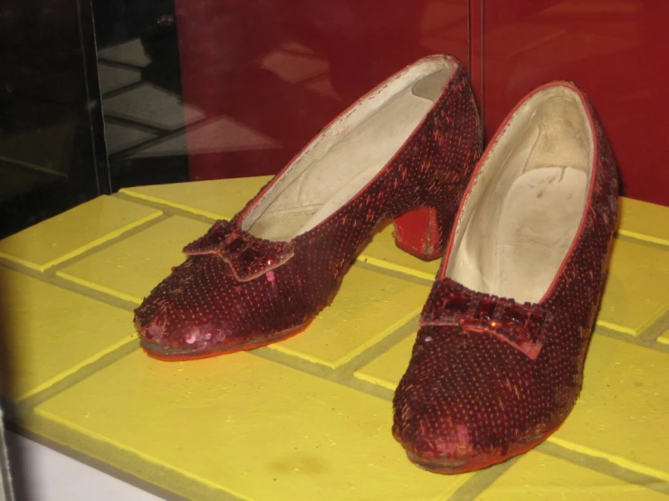 red shoes with sparkly bows are sitting on a counter