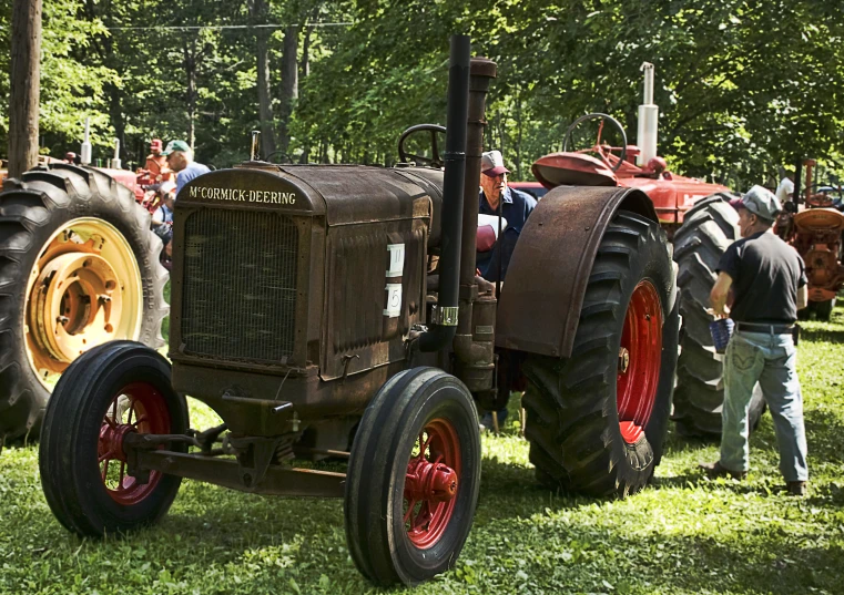 antique farmall equipment displayed at outdoor event