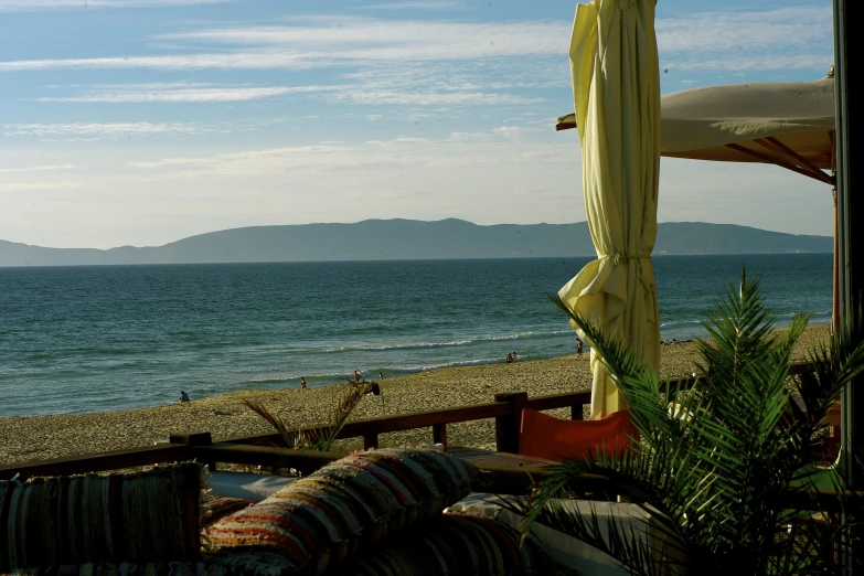 the chairs and umbrellas on the beach are out by the water