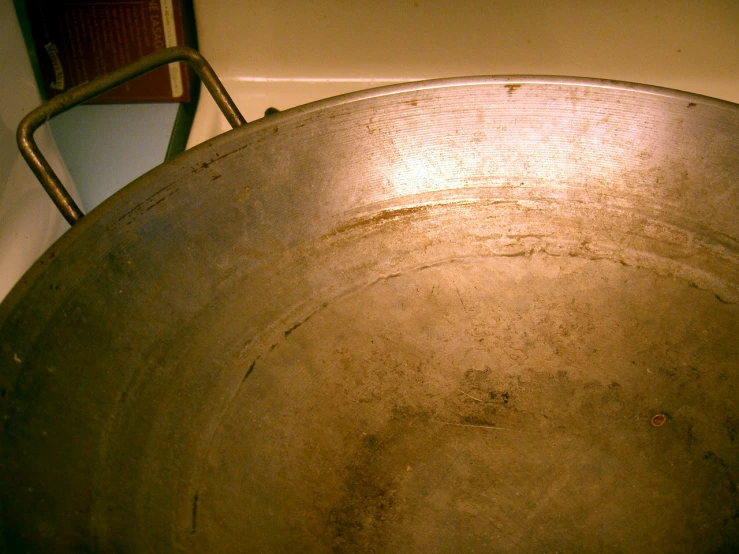 the bottom of an old metal pot sits on a stove