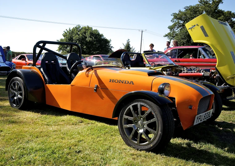 some sort of old fashioned racing car on a field