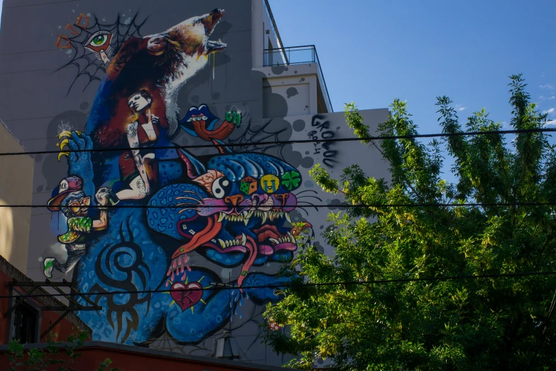a big colorful artwork adorns the side of a building