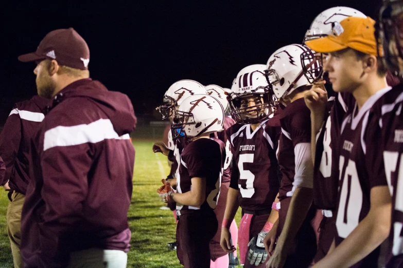 a group of football players standing on a field