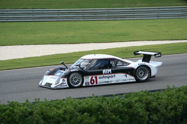 a race car racing down the track on a course