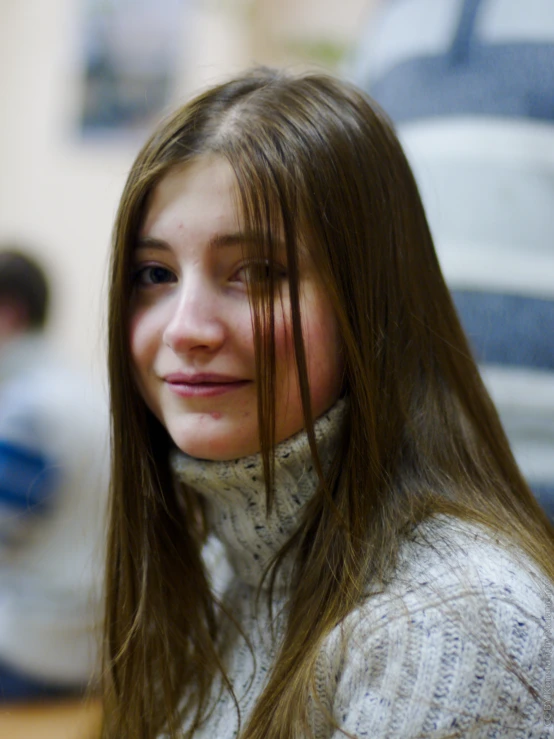 the young woman is smiling with her long hair down