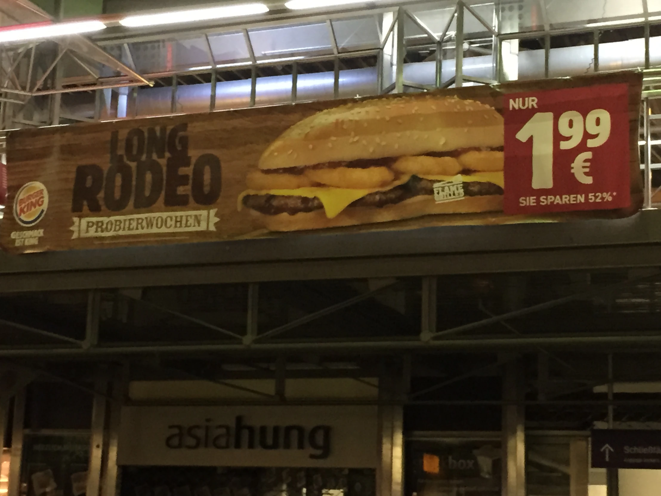 a large sign that has a giant burger on it
